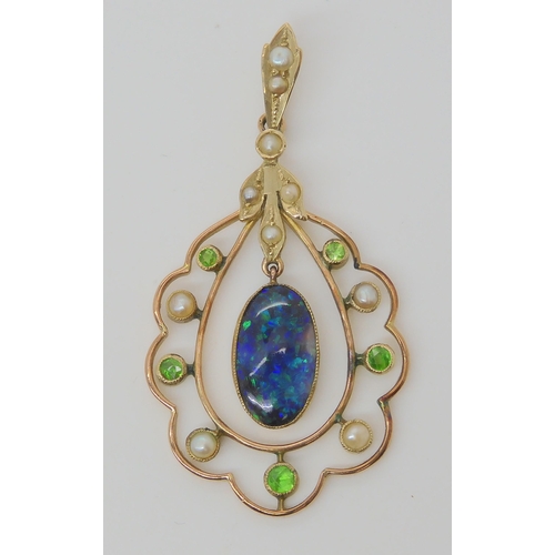 719 - A BLACK OPAL EDWARDIAN PENDANTset with demantoid garnets and split pearls, the solid piece of black ... 