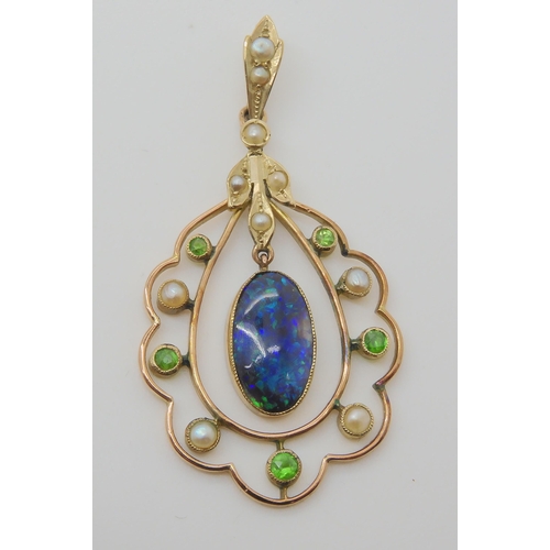 719 - A BLACK OPAL EDWARDIAN PENDANTset with demantoid garnets and split pearls, the solid piece of black ... 