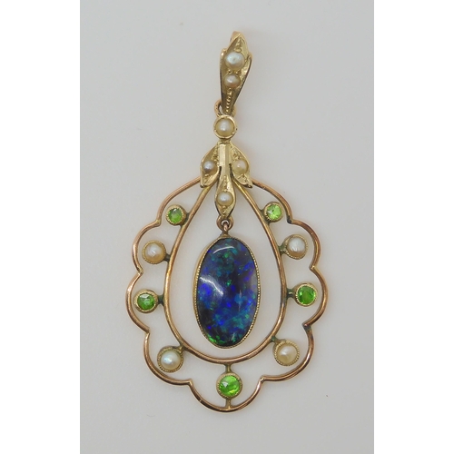 719 - A BLACK OPAL EDWARDIAN PENDANTset with demantoid garnets and split pearls, the solid piece of black ... 