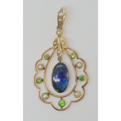 719 - A BLACK OPAL EDWARDIAN PENDANTset with demantoid garnets and split pearls, the solid piece of black ... 