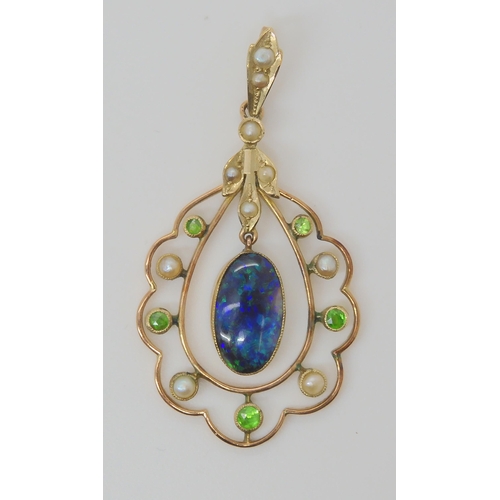 719 - A BLACK OPAL EDWARDIAN PENDANTset with demantoid garnets and split pearls, the solid piece of black ... 