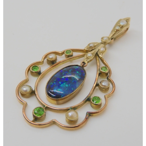 719 - A BLACK OPAL EDWARDIAN PENDANTset with demantoid garnets and split pearls, the solid piece of black ... 