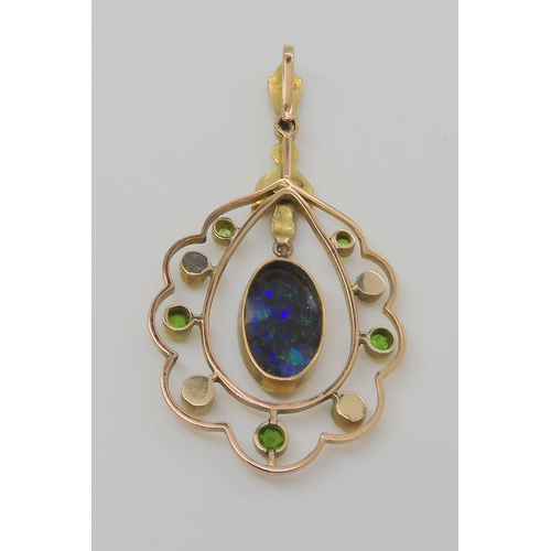 719 - A BLACK OPAL EDWARDIAN PENDANTset with demantoid garnets and split pearls, the solid piece of black ... 