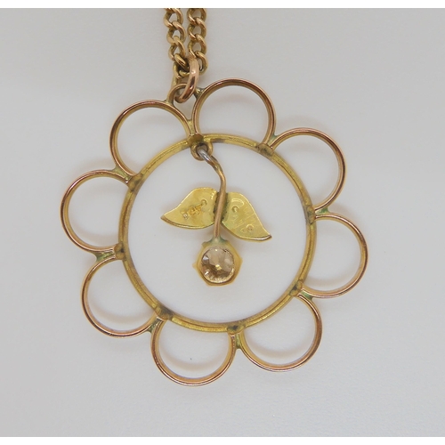 722 - A FLOWER SHAPED EDWARDIAN PENDANTstamped 9ct to the back of the pendant set with a champagne coloure... 