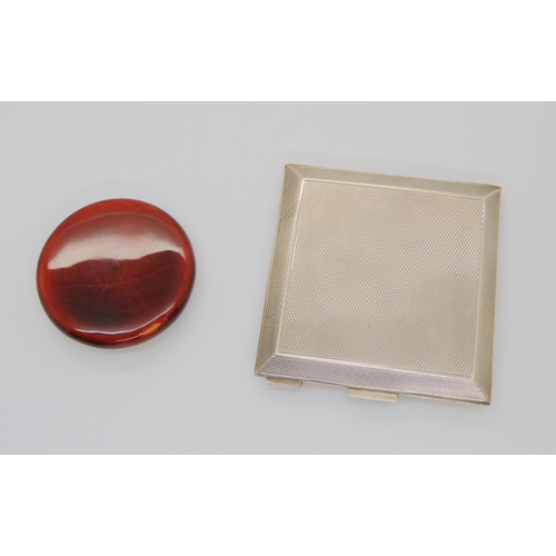 725 - TWO ENAMELLED POWDER COMPACTSa deep orange guilloche enamelled silver square compact with triangular... 