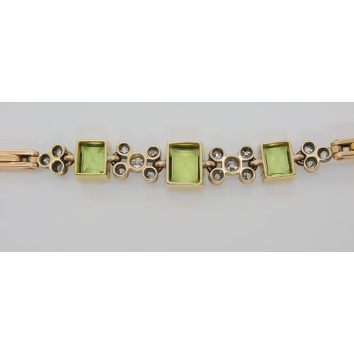 726 - A PERIDOT AND DIAMOND BRACELET & MATCHING RINGthe yellow metal expanding bracelet is stamped Lon... 