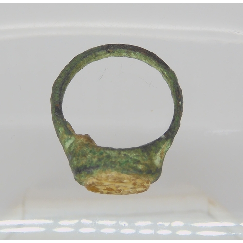 743 - AN OF THE ANTIQUE BRONZE RINGin excavated state, set with an engraved intaglio 'stone' possibly glas... 