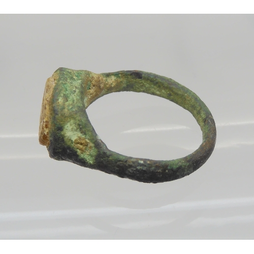 743 - AN OF THE ANTIQUE BRONZE RINGin excavated state, set with an engraved intaglio 'stone' possibly glas... 