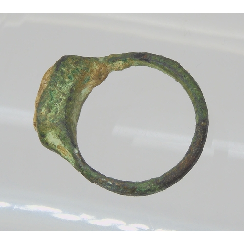 743 - AN OF THE ANTIQUE BRONZE RINGin excavated state, set with an engraved intaglio 'stone' possibly glas... 