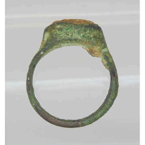 743 - AN OF THE ANTIQUE BRONZE RINGin excavated state, set with an engraved intaglio 'stone' possibly glas... 