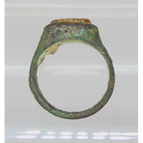 743 - AN OF THE ANTIQUE BRONZE RINGin excavated state, set with an engraved intaglio 'stone' possibly glas... 