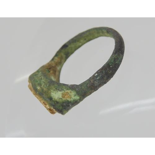 743 - AN OF THE ANTIQUE BRONZE RINGin excavated state, set with an engraved intaglio 'stone' possibly glas... 