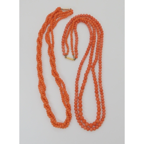 746 - TWO STRINGS OF CORAL BEADSa double string of tapered coral beads, largest bead approx 6mm, length of... 