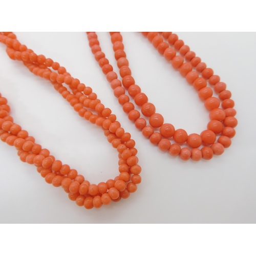 746 - TWO STRINGS OF CORAL BEADSa double string of tapered coral beads, largest bead approx 6mm, length of... 