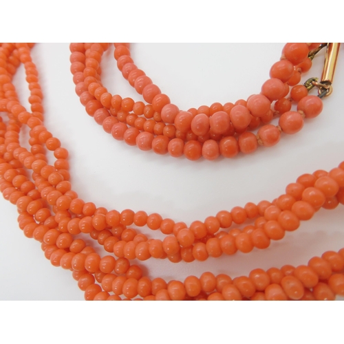 746 - TWO STRINGS OF CORAL BEADSa double string of tapered coral beads, largest bead approx 6mm, length of... 