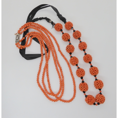 747 - CORAL STATEMENT BEADSa string of woven coral beads, with black glass beads and ribbon strap. Each wo... 