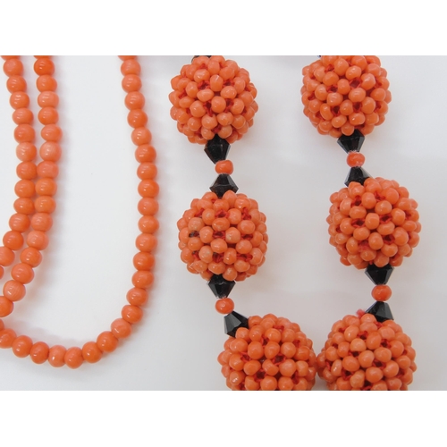 747 - CORAL STATEMENT BEADSa string of woven coral beads, with black glass beads and ribbon strap. Each wo... 