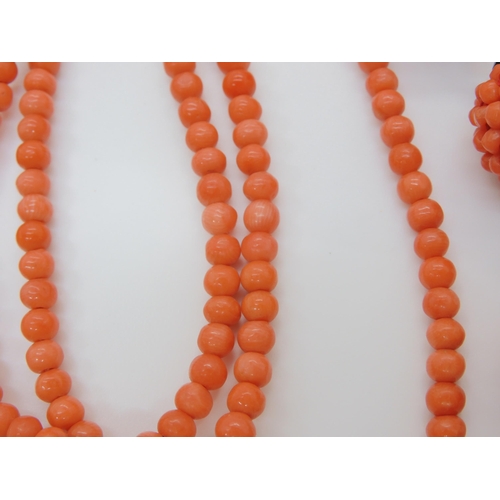 747 - CORAL STATEMENT BEADSa string of woven coral beads, with black glass beads and ribbon strap. Each wo... 