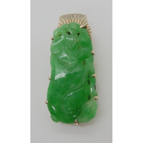 748 - A CHINESE GREEN HARDSTONE CLIP BROOCHmounted in 9ct white gold, the hardstone is carved to both side... 