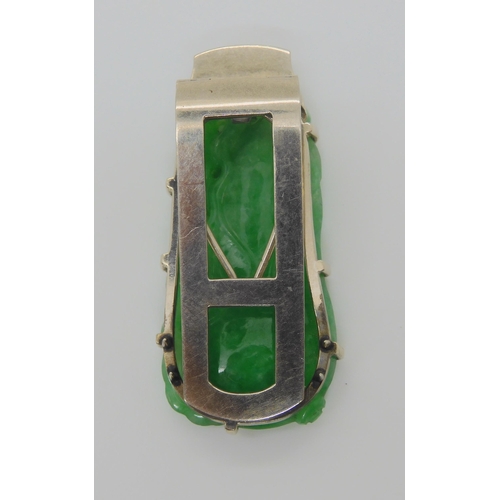 748 - A CHINESE GREEN HARDSTONE CLIP BROOCHmounted in 9ct white gold, the hardstone is carved to both side... 