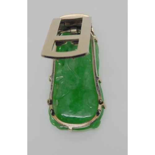 748 - A CHINESE GREEN HARDSTONE CLIP BROOCHmounted in 9ct white gold, the hardstone is carved to both side... 