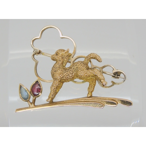 753 - AN ART DECO 9CT LAMB BROOCHset with an aquamarine and garnet, stamped 9ct and A&W to the reverse... 