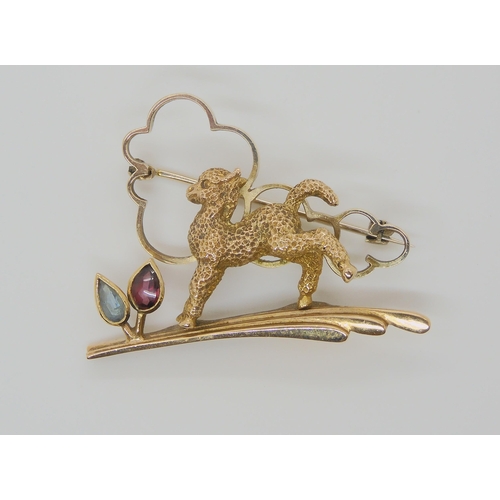 753 - AN ART DECO 9CT LAMB BROOCHset with an aquamarine and garnet, stamped 9ct and A&W to the reverse... 