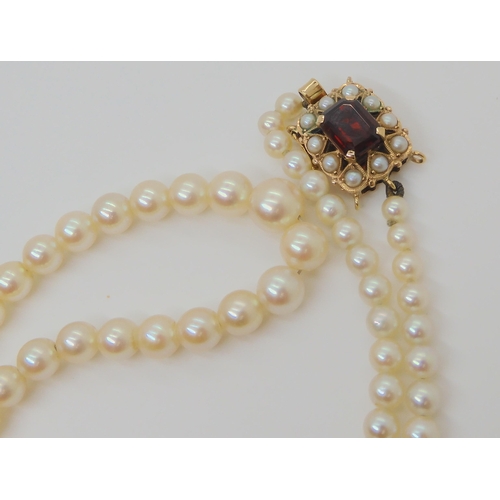 754 - A STRING OF PEARLS with a 9ct gold garnet and pearl clasp, stamped C&F for Cropp & Farr Ltd,... 