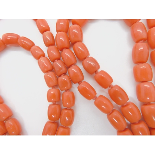 757 - A STRING OF CORAL BARREL SHAPED BEADSlargest bead approx 12.3mm x 9.5mm, length of the long string a... 