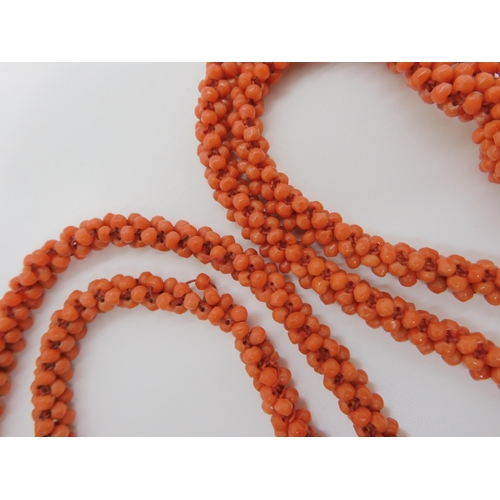 758 - A WOVEN CORAL BEAD NECKLACE WITH A TASSELlength of the necklace 74cm, length of tassel drop 11cm... 