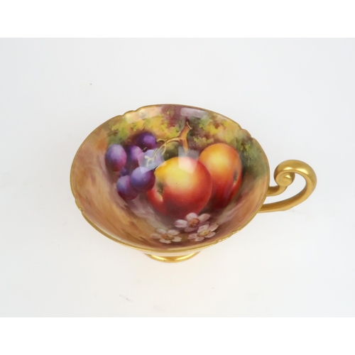 154 - A ROYAL WORCESTER FRUIT PAINTED TEA CUP AND SAUCERthe cup with apples and grapes, the saucer with pl... 