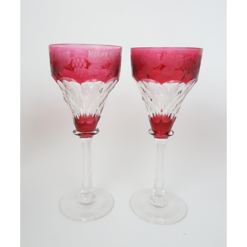 157 - A SET OF SIX RUBY FLASHED AND CUT GLASSESwith etched vine decoration, 19cm high... 