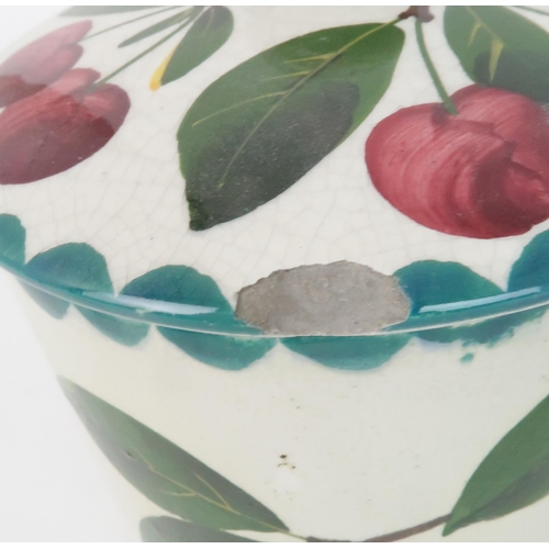 183 - A WEMYSS BISCUIT JAR AND COVERpainted with cherries, a Cherry preserve pot, a orange painted ma... 