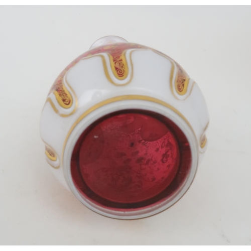 208 - A BOHEMIAN GLASS VASEthe cranberry body overlaid with white glass and cut back with a roundel, paint... 