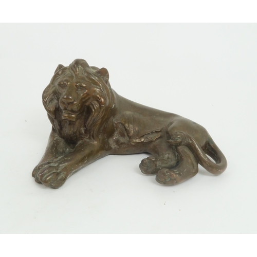 213 - A BRONZE SCULPTURE OF A LION22cm long together with a Black Forest Sculpture of a bear (2)... 