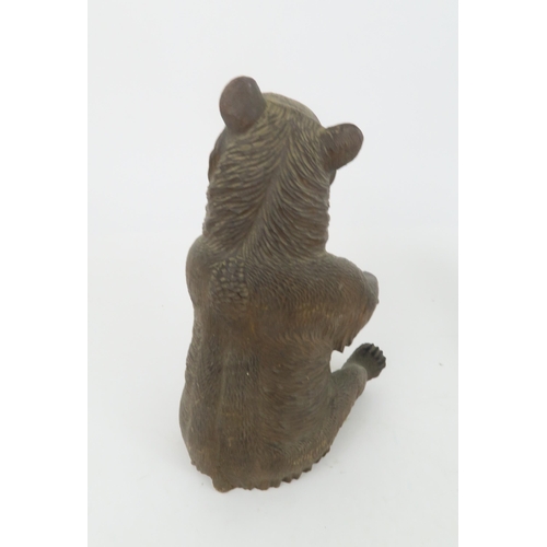 213 - A BRONZE SCULPTURE OF A LION22cm long together with a Black Forest Sculpture of a bear (2)... 