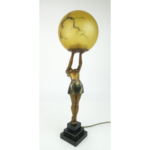 214 - AN ART DECO LADY LAMPthe figure bending backwards supporting the amber glass shade, 60cm high... 