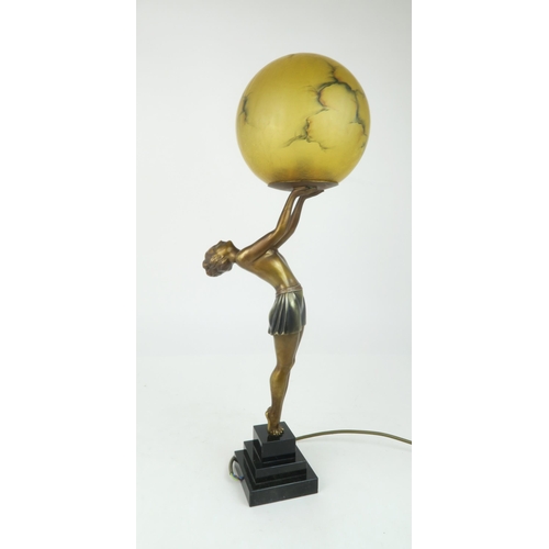 214 - AN ART DECO LADY LAMPthe figure bending backwards supporting the amber glass shade, 60cm high... 