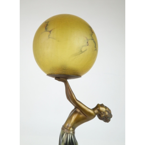 214 - AN ART DECO LADY LAMPthe figure bending backwards supporting the amber glass shade, 60cm high... 