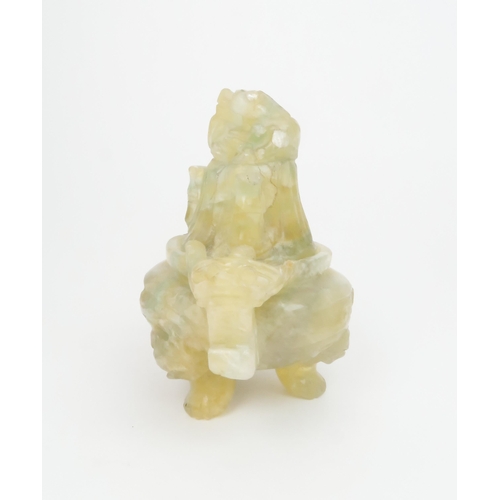 305 - A CHINESE GREEN QUARTZ INCENSE BURNERcarved with grotesque handles, kylin finial and on mask and paw... 