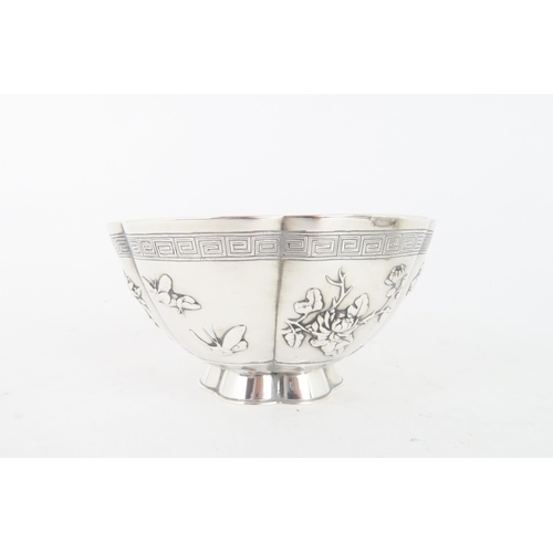 306 - A CHINESE SILVER LOBED BOWLcast with panels of birds, butterflies and foliage, within key pattern ba... 