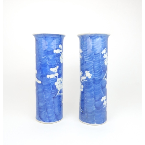 309 - A PAIR OF CHINESE BLUE AND WHITE SPILL VASESpainted with blossoming branches on a blue wash ground, ... 