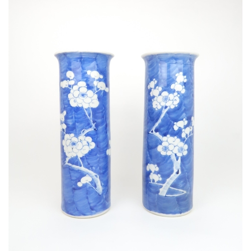 309 - A PAIR OF CHINESE BLUE AND WHITE SPILL VASESpainted with blossoming branches on a blue wash ground, ... 