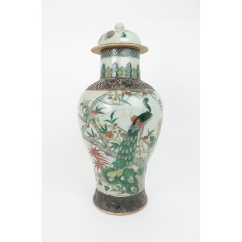 310 - A CHINESE FAMILLE VERTE BALUSTER VASE AND A DOMED COVERpainted with a peacock and foliage within bro... 