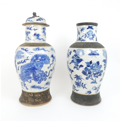 311 - TWO CHINESE BLUE AND WHITE CRACKLEWARE ARCHAIC STYLE VASESone painted with buddhistic lions and clou... 