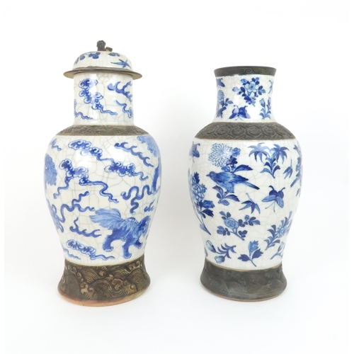 311 - TWO CHINESE BLUE AND WHITE CRACKLEWARE ARCHAIC STYLE VASESone painted with buddhistic lions and clou... 