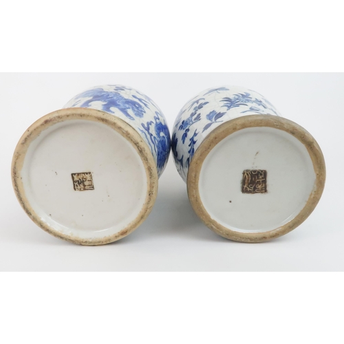 311 - TWO CHINESE BLUE AND WHITE CRACKLEWARE ARCHAIC STYLE VASESone painted with buddhistic lions and clou... 