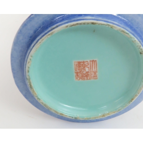 318 - A CHINESE GU VASEpainted with leaf shaped panels of foliage reserved on a blue foliate incised groun... 