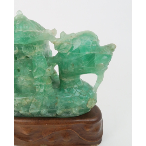 321 - A CHINESE GREEN FLUORSPAR LAMP CARVINGcarved as a dragon boat, seated on a carved hardwood base, 24c... 