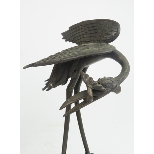 322 - A PAIR OF CHINESE BRONZE JOSS STICK HOLDERSeach cast as storks with lily pads and standing on waves ... 